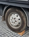 solid and rigid natural cork wedges under the wheels of a forklift truck cars.jpg